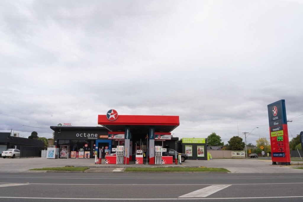 Octane service station with a Caltex canopy and price sign, seen from across the road