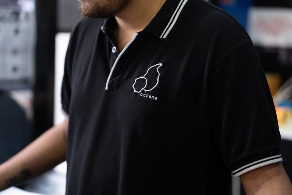 Octane team member wearing a black Octane polo shirt