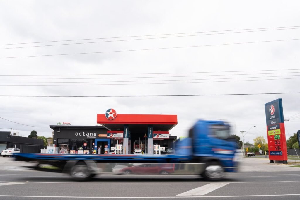 Truck driving past an Octane service station with a Caltex canopy